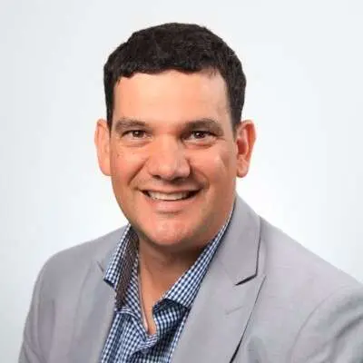 Smiling person in checkered shirt