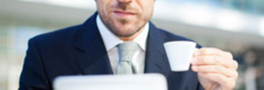 Professional with espresso cup and tablet