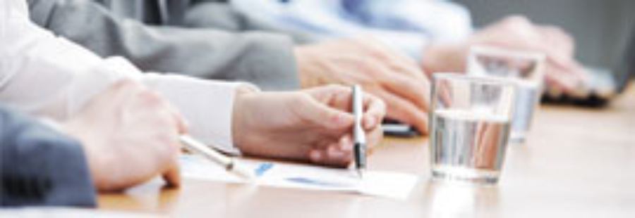 Close-up of hands writing during conference