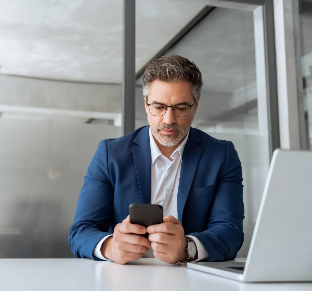 Man in suit using smartphone